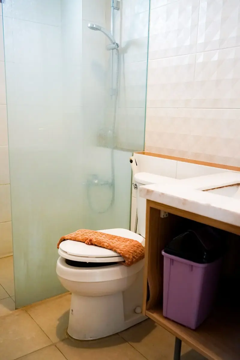 Open toilet tank showing flapper, fill valve, float, and chain components