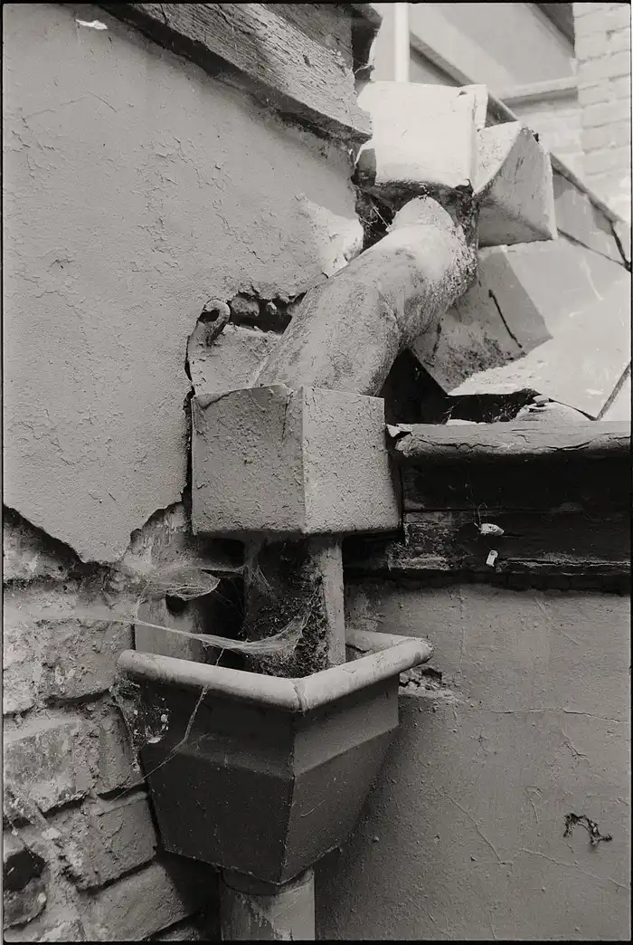 Example: rusty, corroded pipe on a deteriorating wall